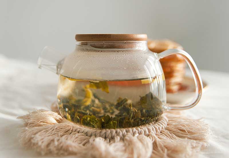 a glass pitcher of green tea contains EG G for anti aging